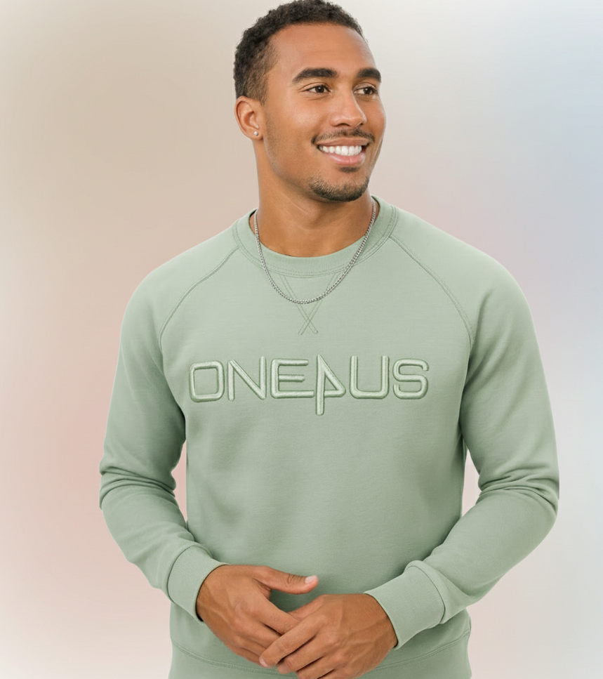 Man wearing a light green sweatshirt with 'ONEPLUS' logo on a gradient background