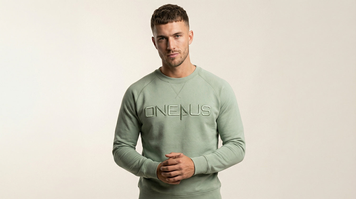 Catalog Man wearing a green 'Onepus' sweatshirt against a beige background