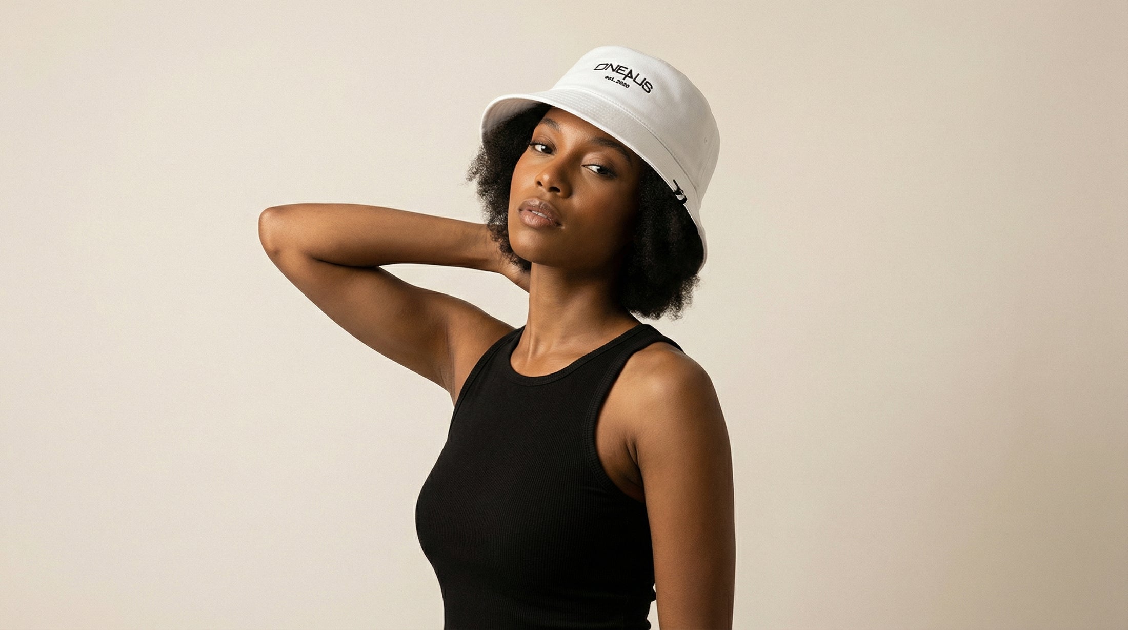 Catalog woman wearing a white cap with branding on a beige background