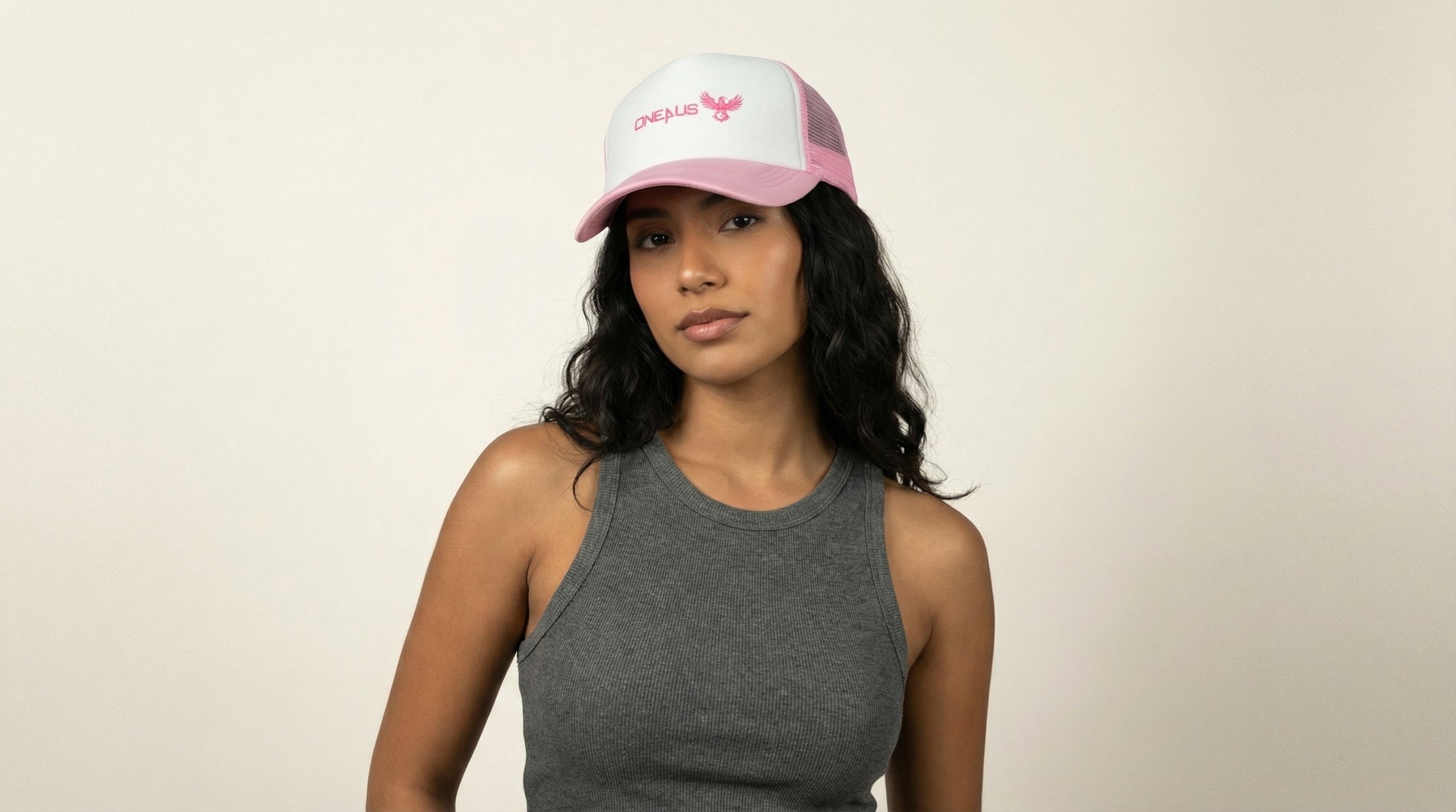 Catalog woman wearing a pink cap with text on a beige background