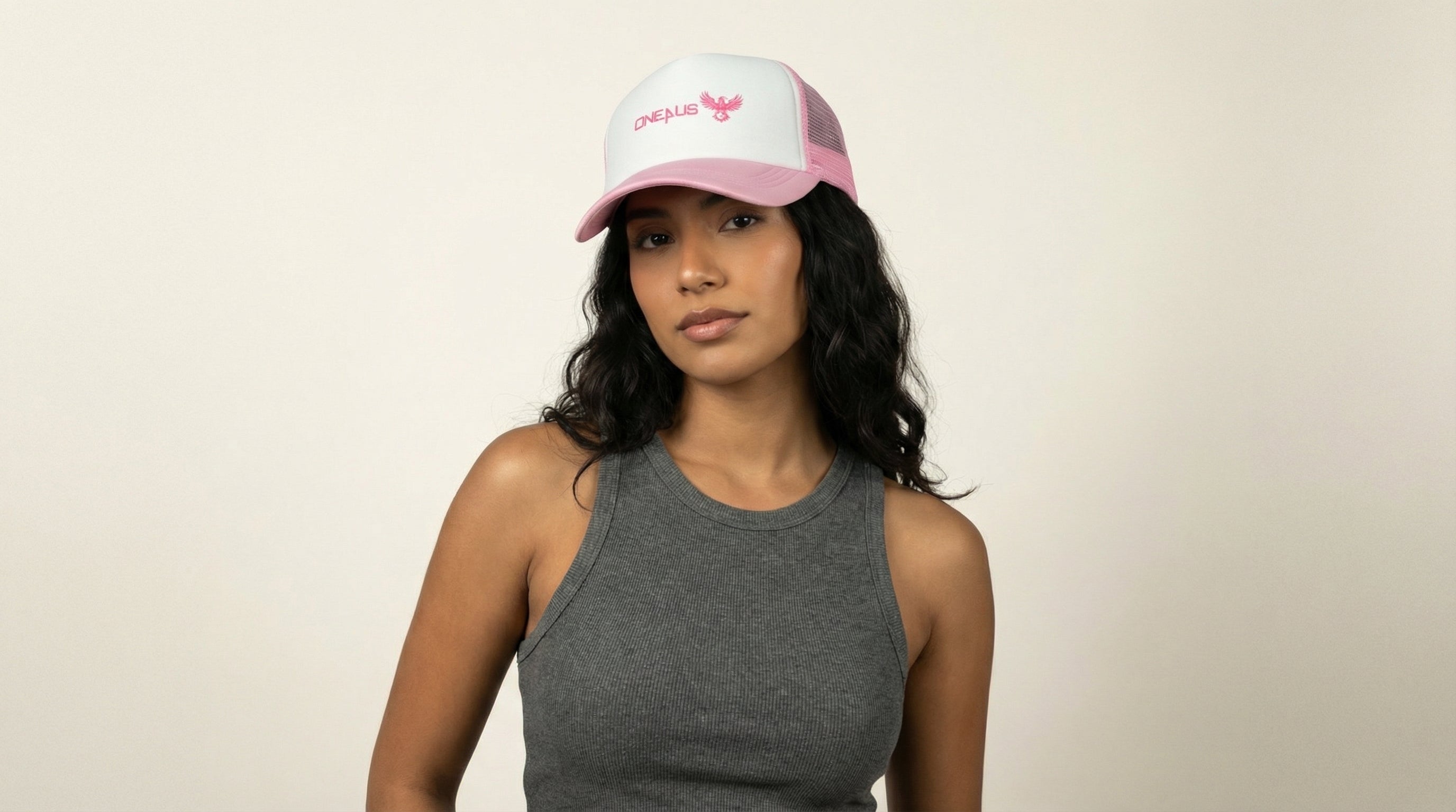 Catalog woman wearing a pink cap with text on a beige background