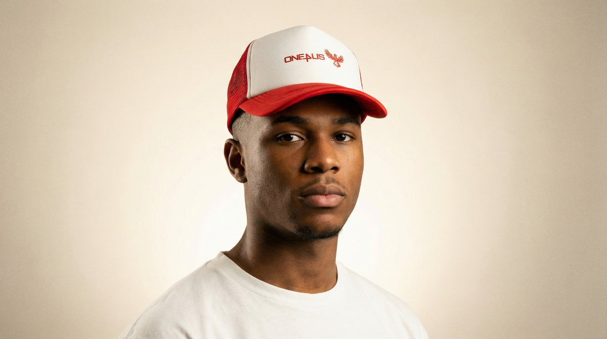 Catalog man wearing a red and white cap with 'One4Us' branding on a beige background