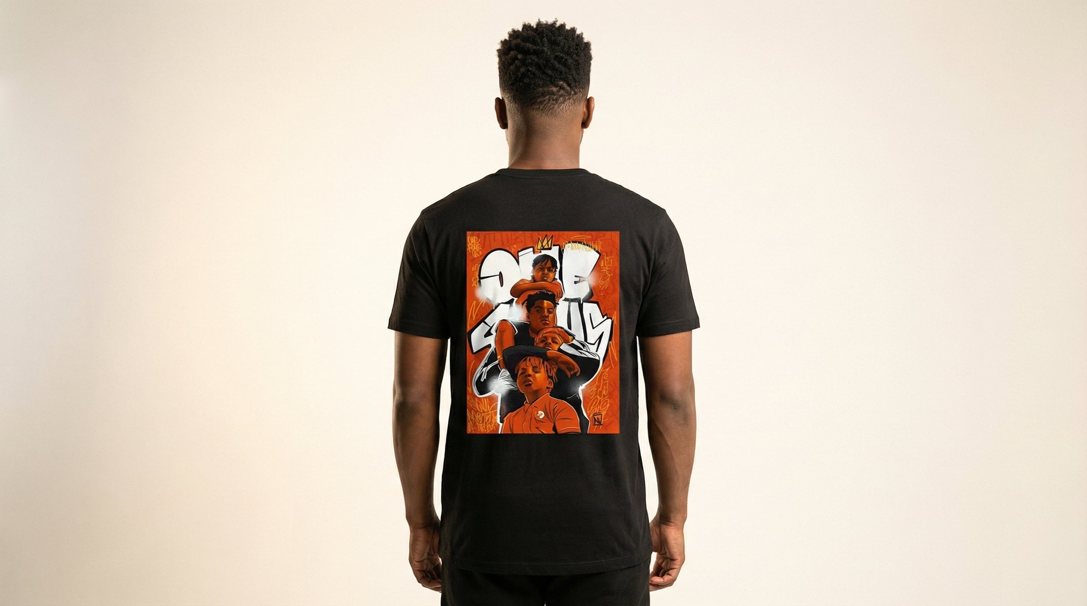 Catalog man wearing a black t-shirt with a colorful graphic on the back against a beige background