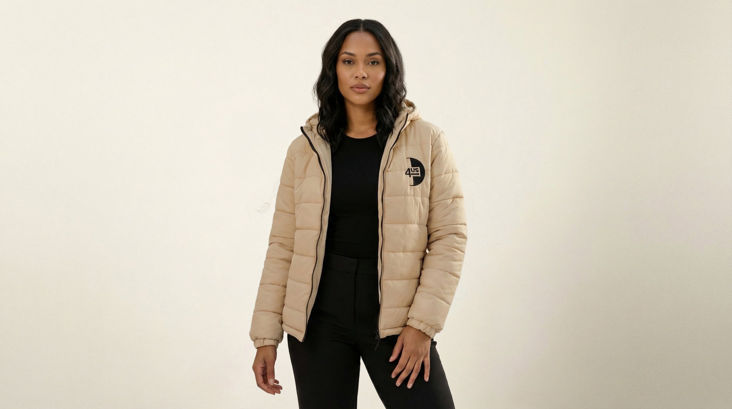 Catalog woman wearing a beige puffer jacket with a brand logo on a beige background