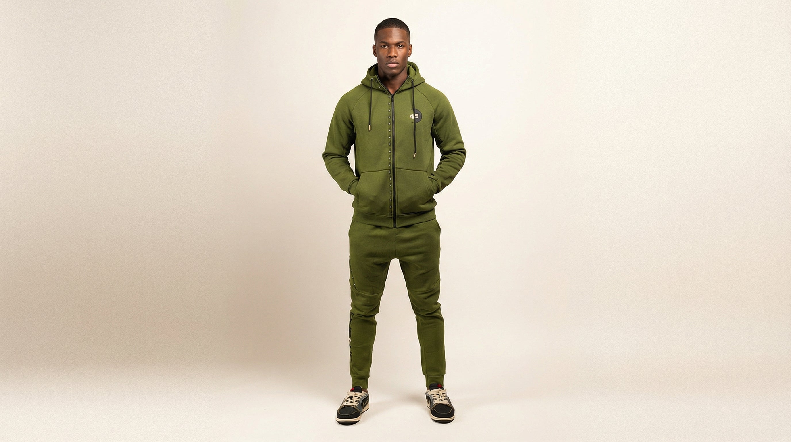 Catalog man wearing a green tracksuit on a white background