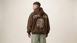 Catalog man wearing a brown hoodie with 'ONE4US' design on the back against a beige background