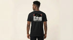 Catalog man wearing a black t-shirt with a graphic design on the back against a beige background